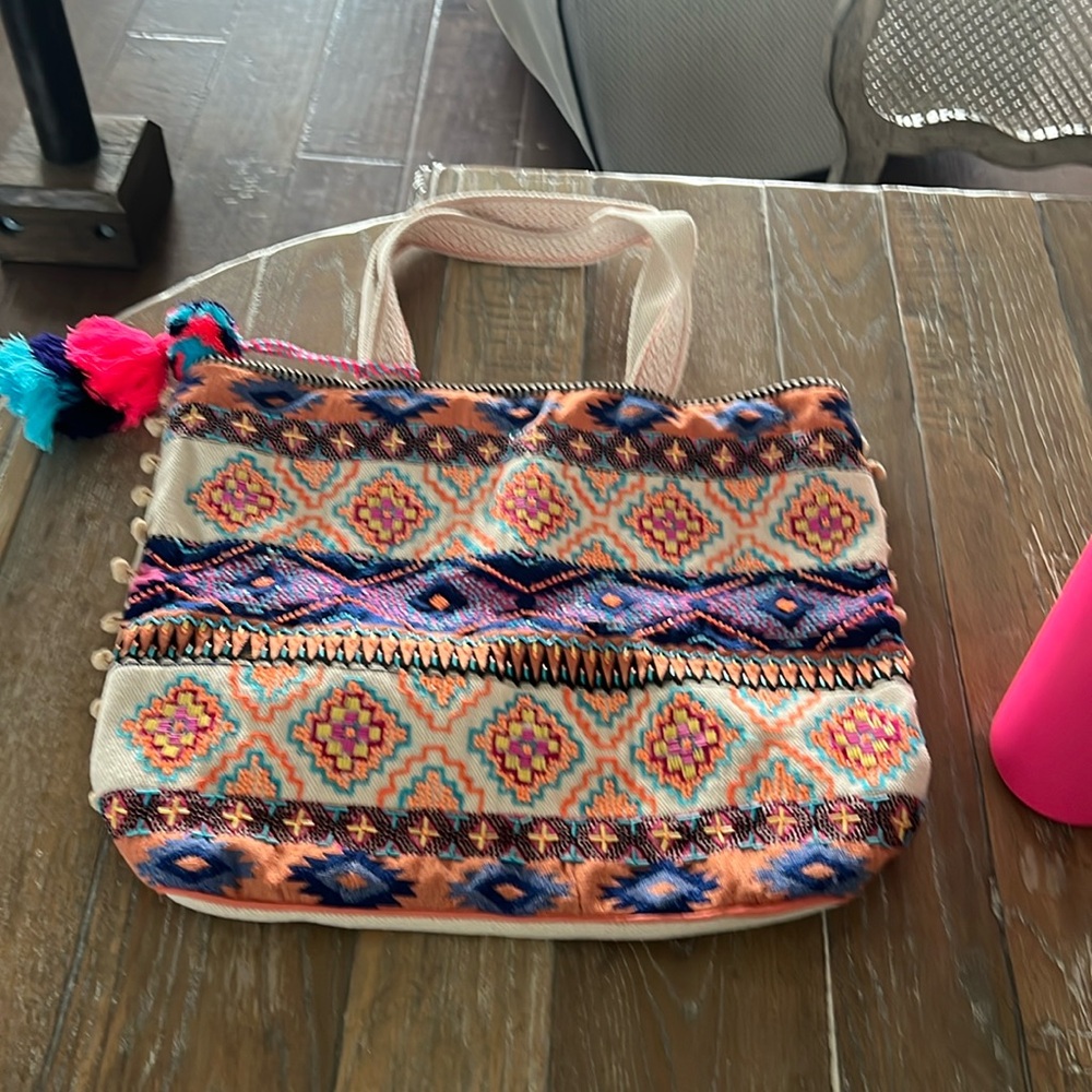 Medium-Large tote bag. It has stitching and beading work on the front